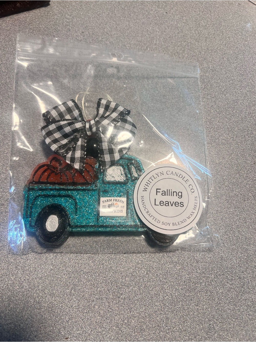 Whitlyn Candle Co. Falling Leaves  in a teal glitter truck with pumpkins